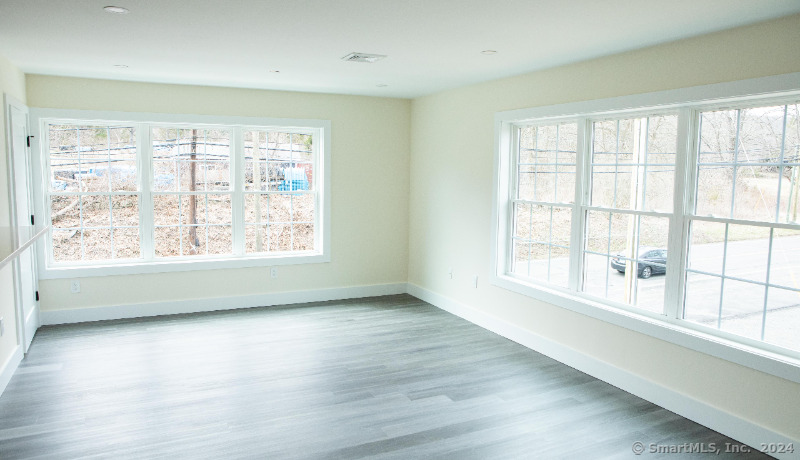 887 Federal Road, Unit 5 Brookfield, CT 06804 - Photo 13 of 15 wooden floor in an empty room with a window