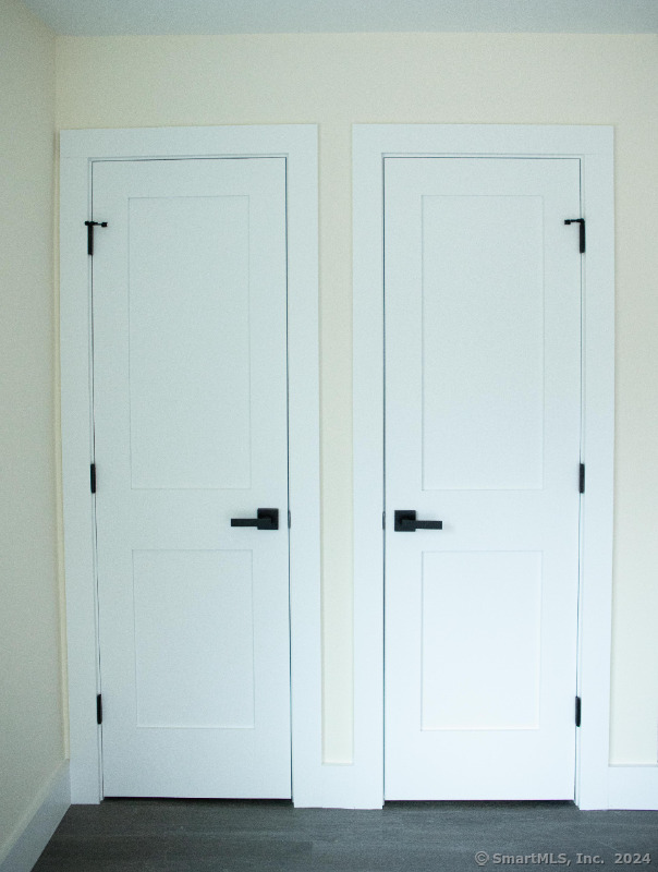 887 Federal Road, Unit 5 Brookfield, CT 06804 - Photo 14 of 15 a view of a hallway with wooden floor