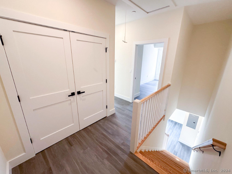 887 Federal Road, Unit 5 Brookfield, CT 06804 - Photo 15 of 15 a view of a hallway with wooden floor and closet
