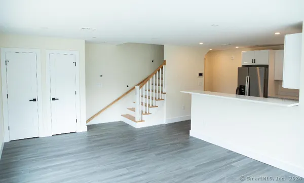 a kitchen with stainless steel appliances a refrigerator sink and microwave