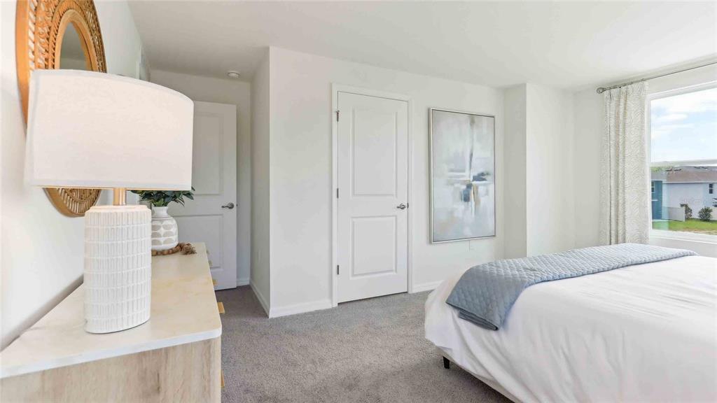 8196 Southwest 67th Avenue Ocala, FL 34476 - Photo 13 of 20 a bedroom with a bed and a chandelier