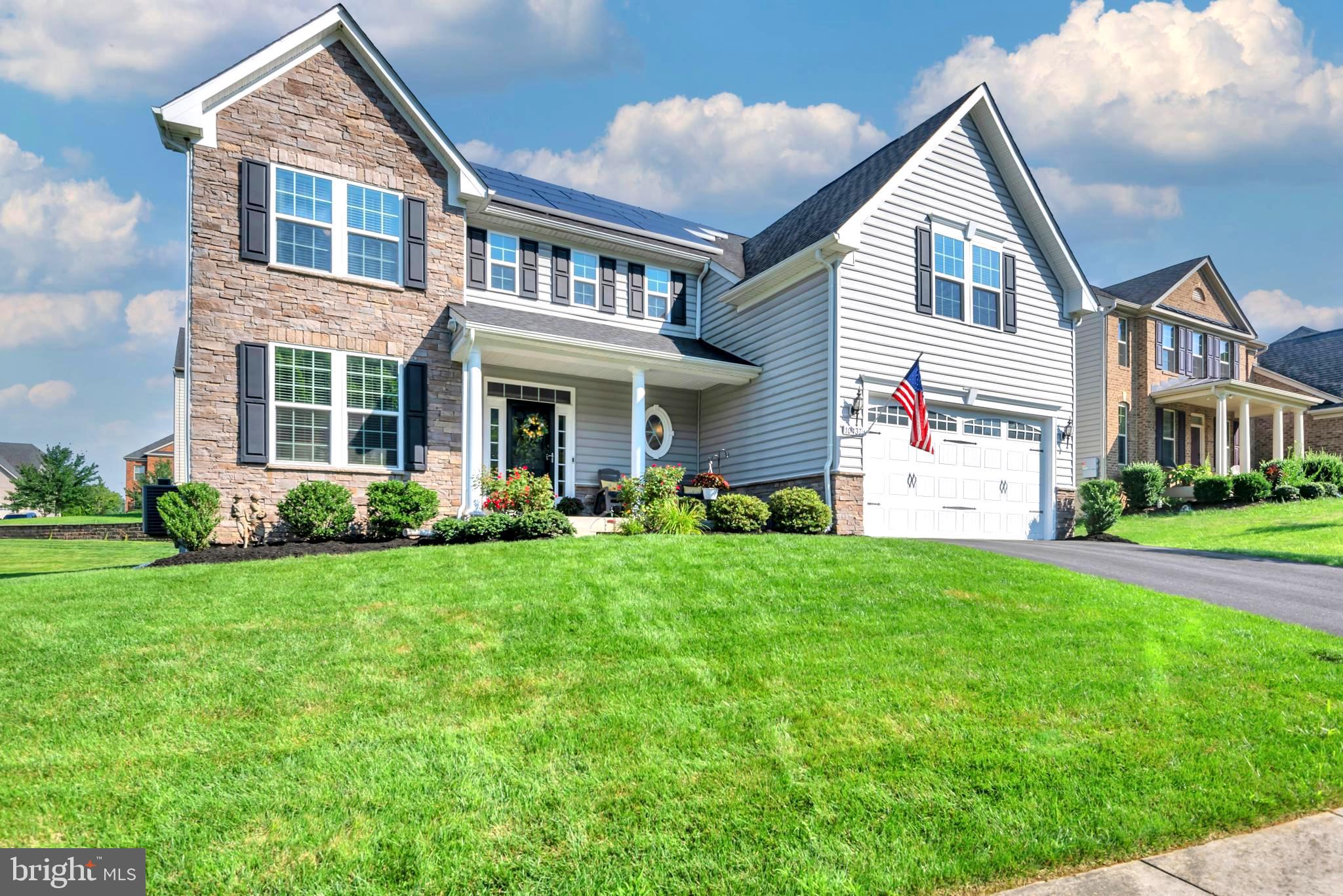 a front view of a house with a yard and porch