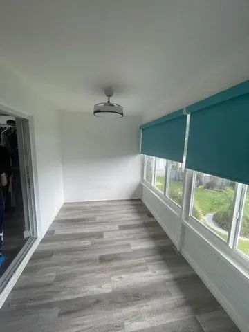 a view of an empty room with a window