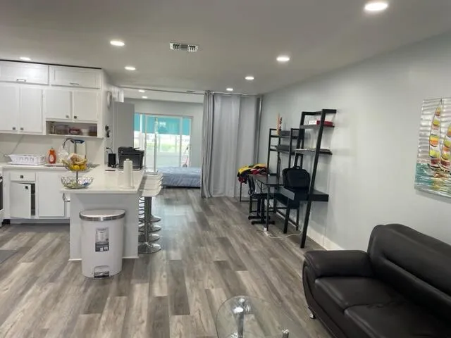 a living room with furniture and a wooden floor