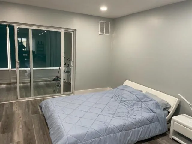 a bed sitting in a bedroom next to a window