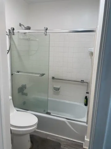 a bathroom with a shower and a toilet