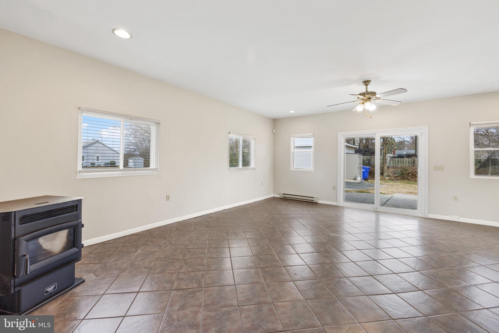104 Barren Ridge Road Chester, MD 21619 - Photo 20 of 41 Pellet stove and sliders to back yard