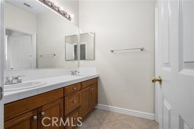 18 Coriander Irvine, CA 92603 - Photo 17 of 29 a bathroom with a double vanity sink and mirror