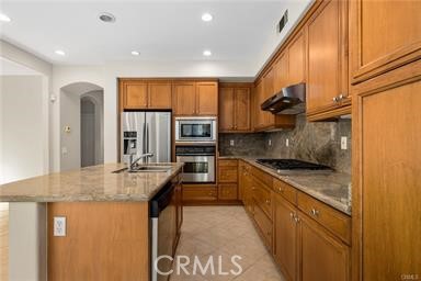 18 Coriander Irvine, CA 92603 - Photo 3 of 29 a kitchen with stainless steel appliances granite countertop a sink a stove and a refrigerator