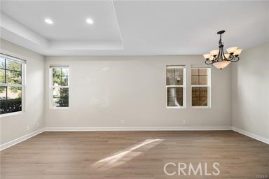 18 Coriander Irvine, CA 92603 - Photo 8 of 29 an empty room with wooden floor and windows