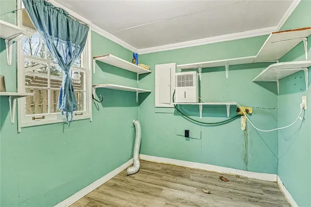 a view of a room with wooden floor and windows