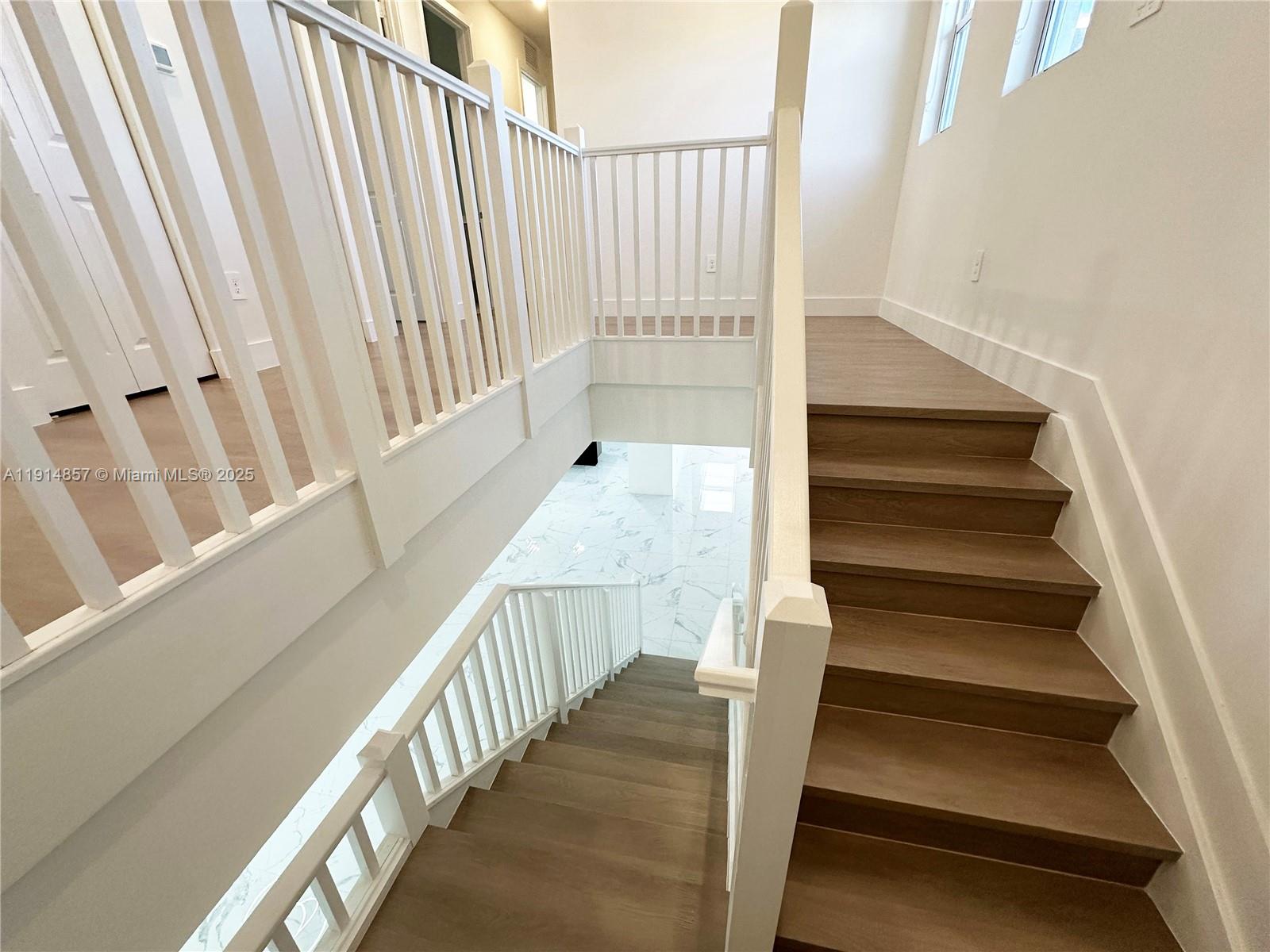 12273 Southwest 44th Street Davie, FL 33330 - Photo 15 of 31 a view of staircase with lots of frames on wall and a window