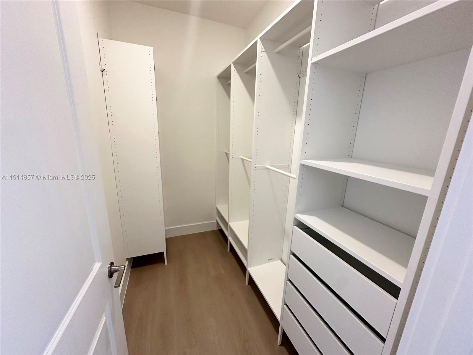 12273 Southwest 44th Street Davie, FL 33330 - Photo 27 of 31 a view of walk in closet with empty racks
