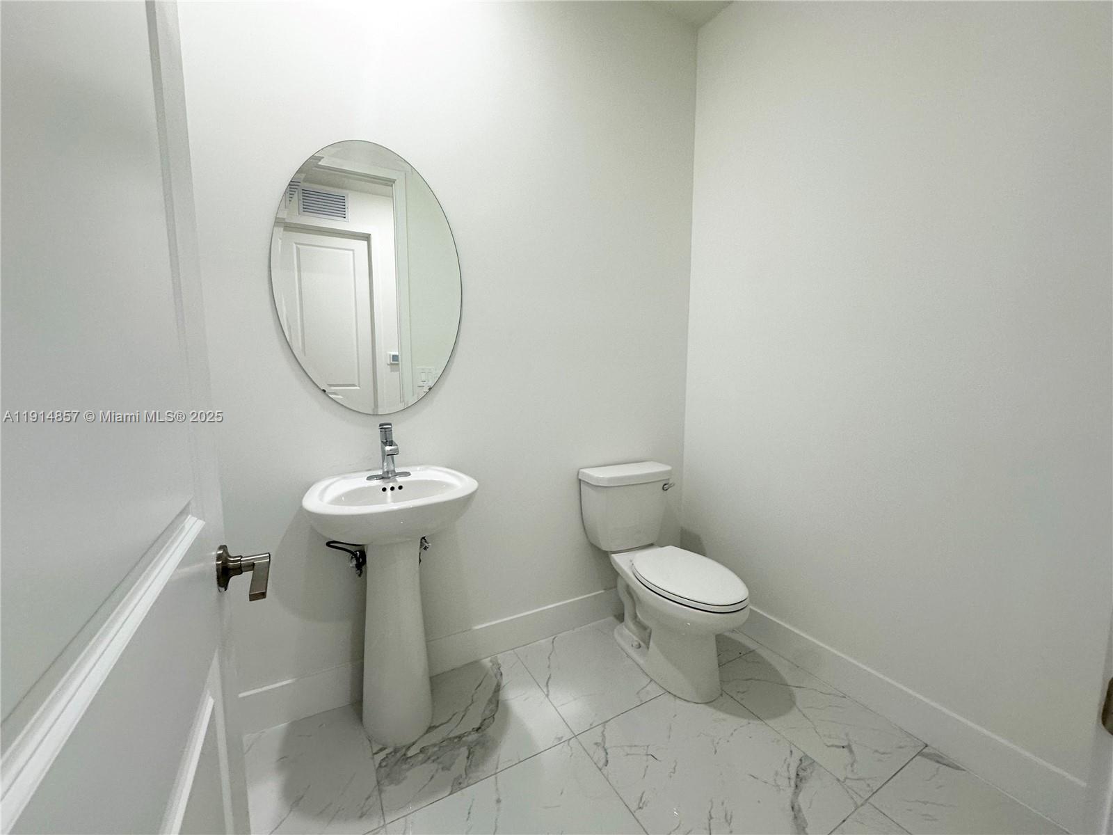 12273 Southwest 44th Street Davie, FL 33330 - Photo 4 of 31 a bathroom with a toilet a sink and a mirror