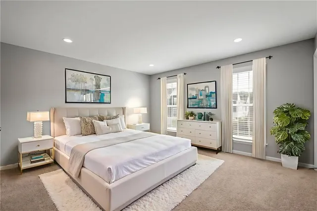 a spacious bedroom with a large bed and a window