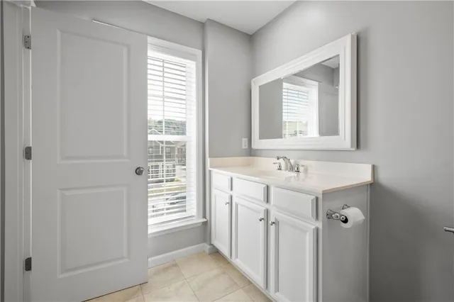 a bathroom with a sink a mirror and a window