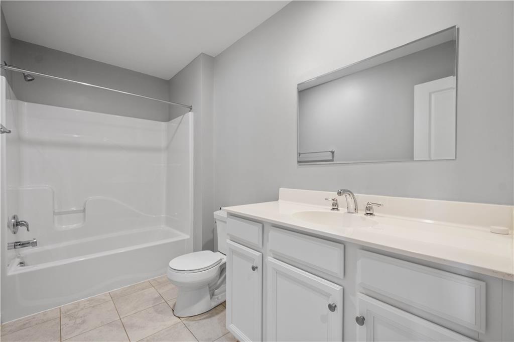 2013 Ashton Row Bridgeville, PA 15017 - Photo 23 of 33 a bathroom with a toilet a sink a mirror and a bathtub