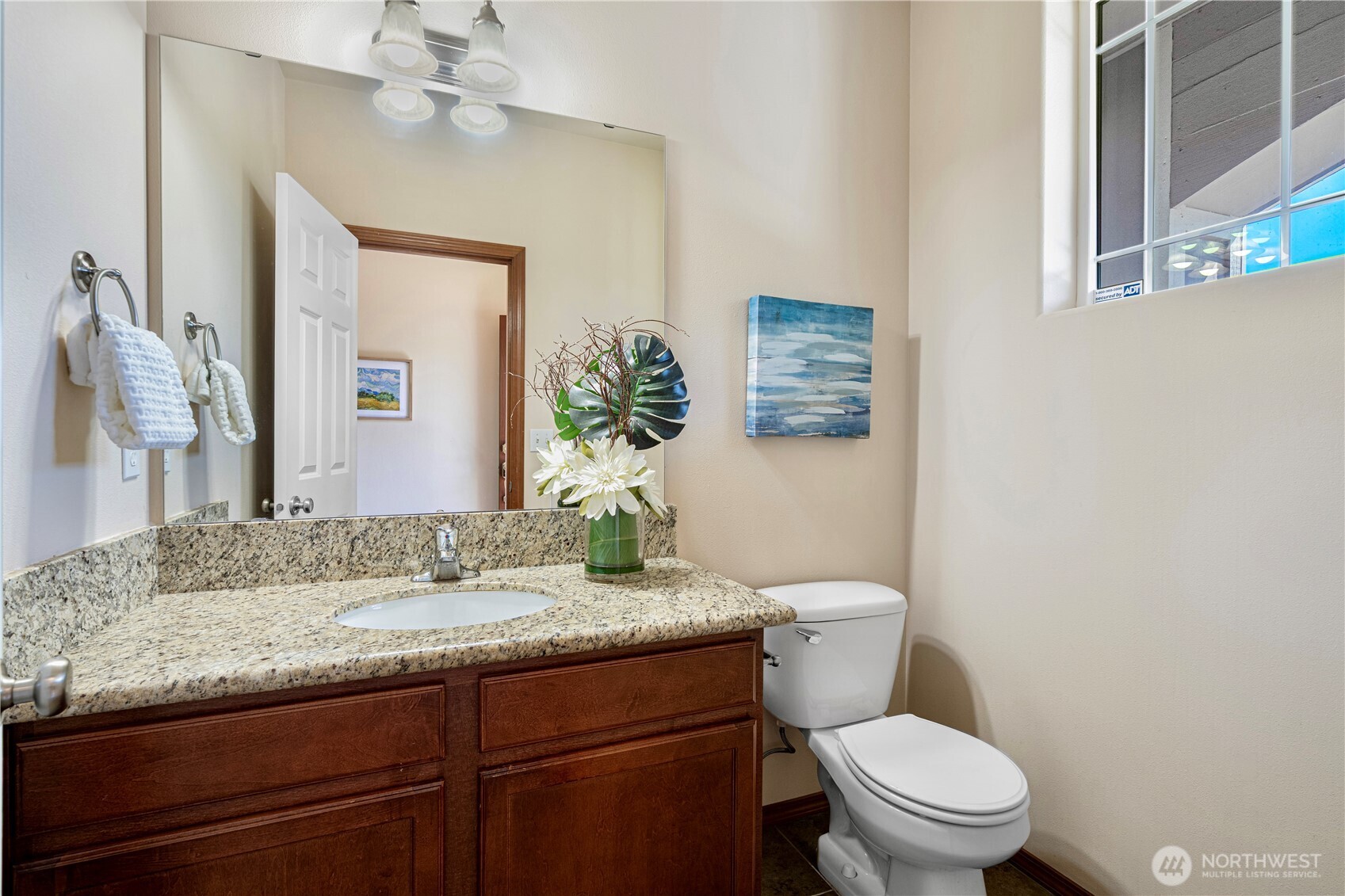 14611 46th Avenue Southeast Bothell, WA 98012 - Photo 4 of 24 a bathroom with a granite countertop toilet sink and mirror