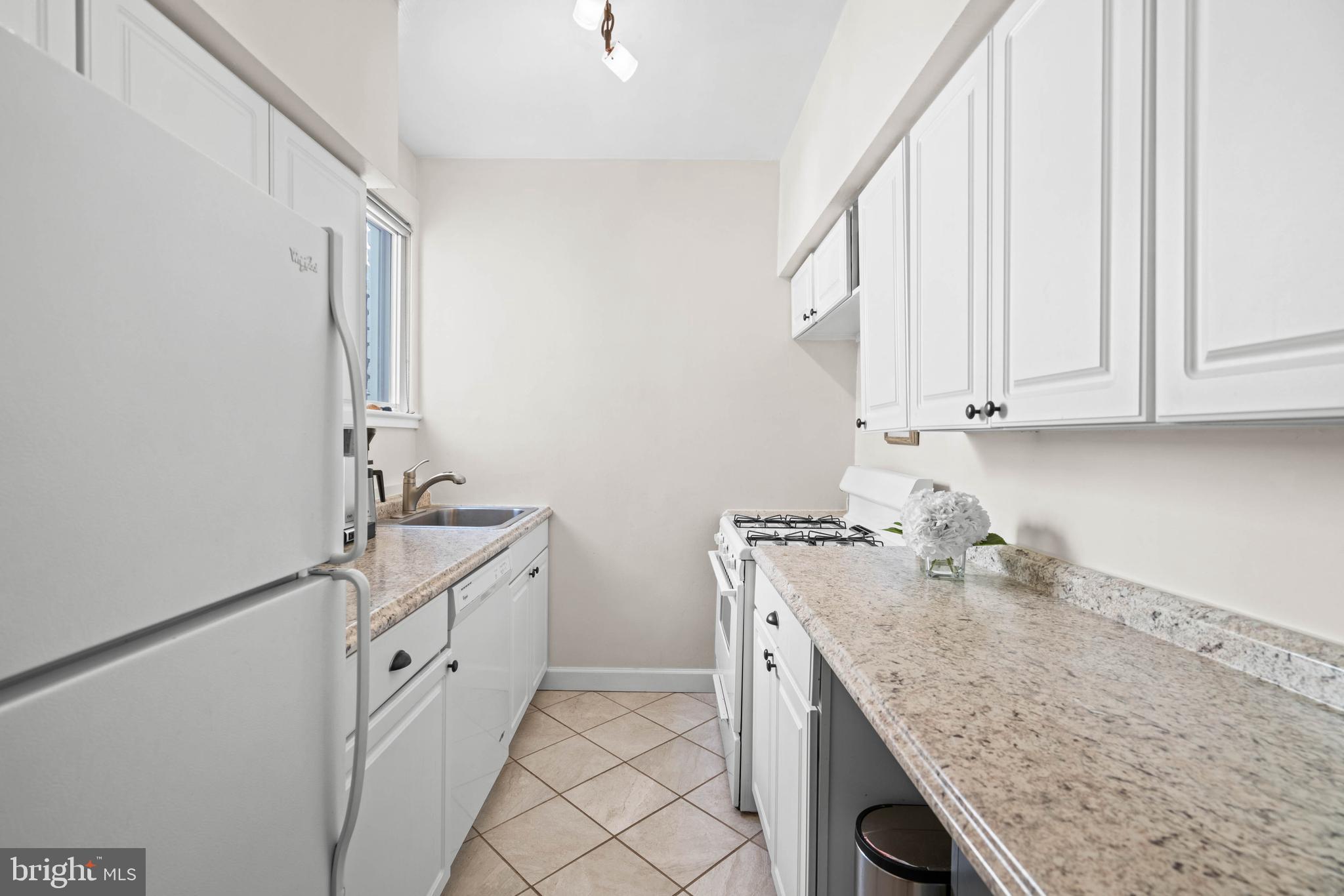 1656 Avon Place Northwest Washington, DC 20007 - Photo 14 of 20 a room with granite countertop white cabinets and sink
