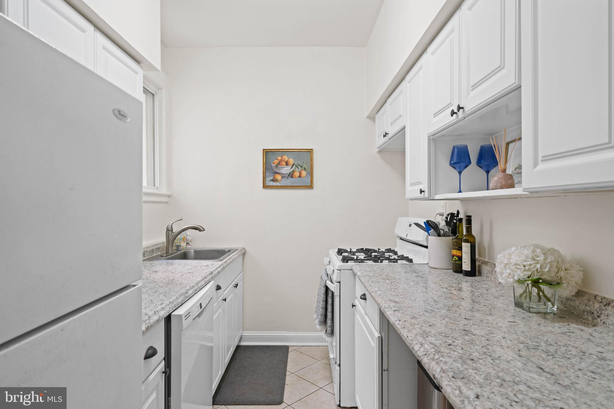 1656 Avon Place Northwest Washington, DC 20007 - Photo 5 of 20 a kitchen with stainless steel appliances granite countertop a sink and cabinets