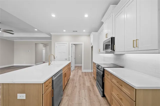 a kitchen with a sink stove and cabinets