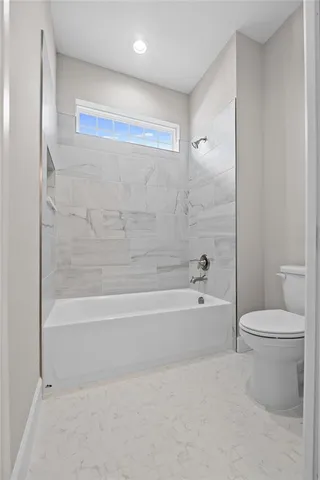 a bathroom with a bathtub and a toilet
