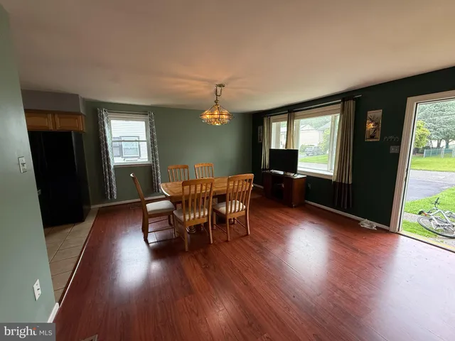 a view of a dining room with furniture and window