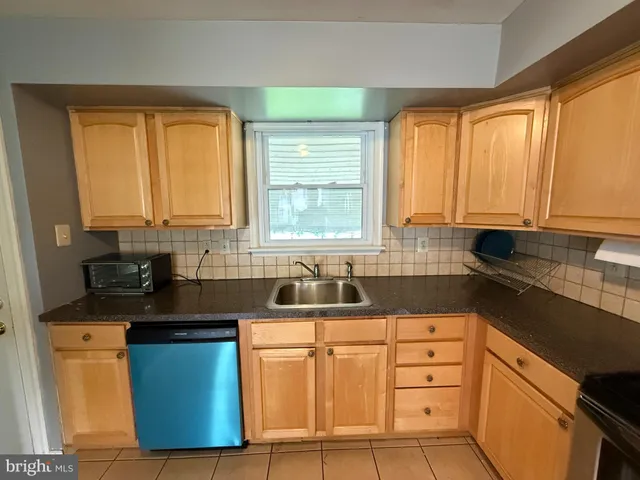 a kitchen with appliances cabinets and a sink