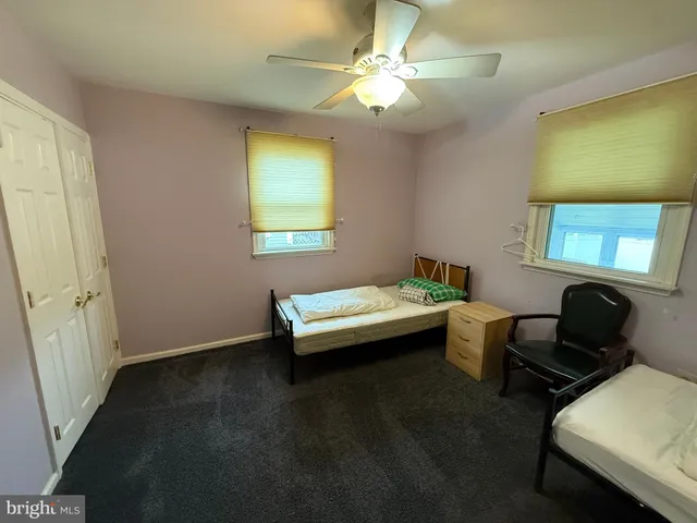 a room with wooden floor and windows