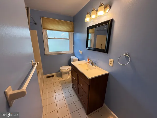 a bathroom with a sink a toilet and mirror
