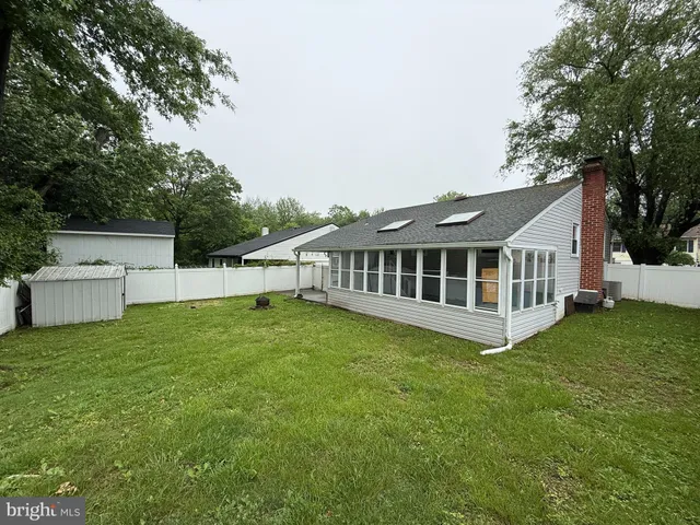 a view of a house with a backyard