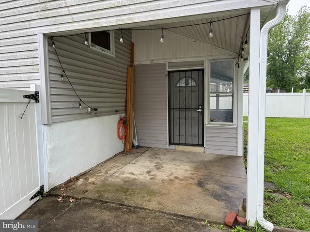 a view of yellow house with a large parking space