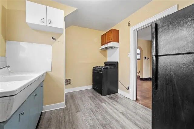 a kitchen with a refrigerator and a sink