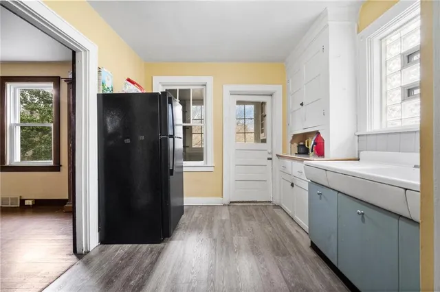 a kitchen with a refrigerator and a sink