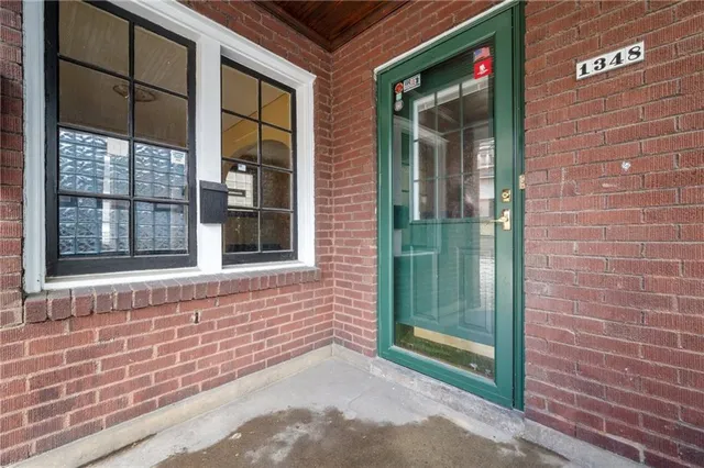 a view of a brick house with a large window