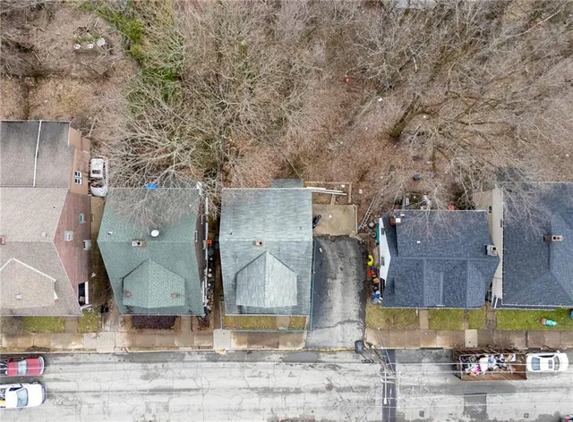 an aerial view of residential houses with outdoor space