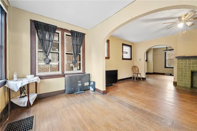 a spacious bedroom with a bed and wooden floor