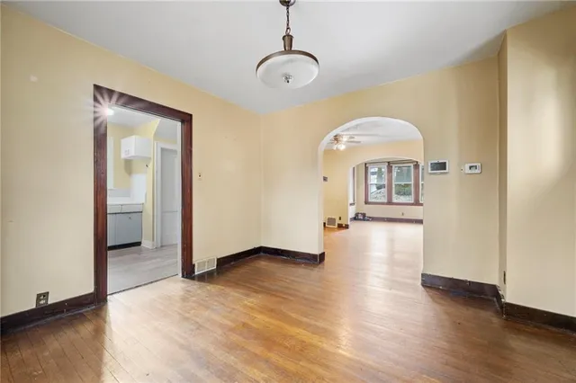 a view of a room with wooden floor staircase and a living room