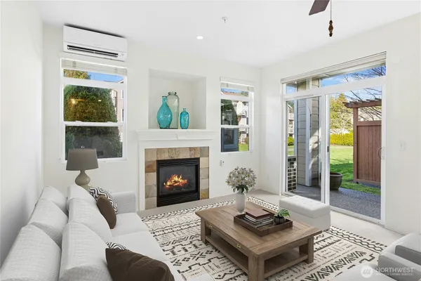 a living room with furniture a ceiling fan and a rug