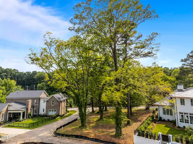 a front view of a multi story residential apartment building with a yard