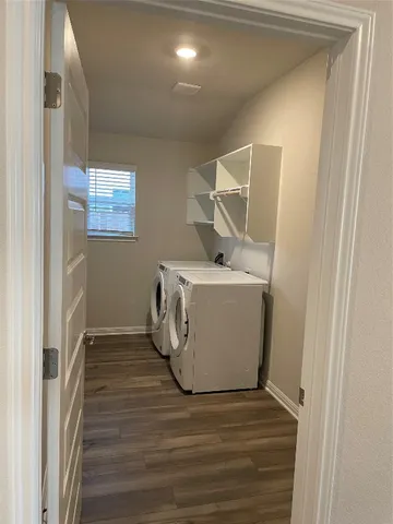 a kitchen with granite countertop a stove and a wooden floors