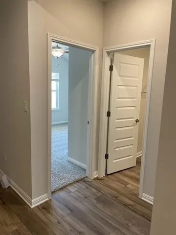 a bathroom with a granite countertop toilet and a sink