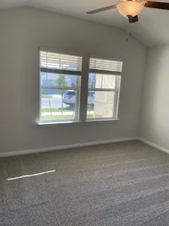 a bathroom with a granite countertop bathtub shower sink vanity and toilet