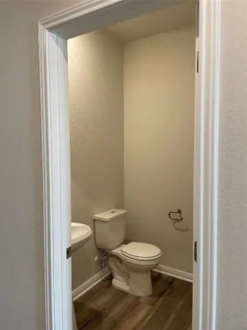 an empty room with wooden floor and a window