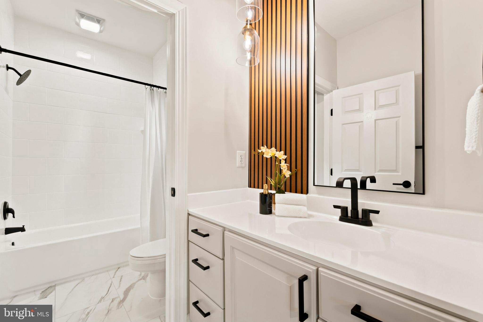 9313 Harrisons Farm Way Laytonsville, MD 20882 - Photo 45 of 77 a bathroom with a sink and a mirror with bathtub