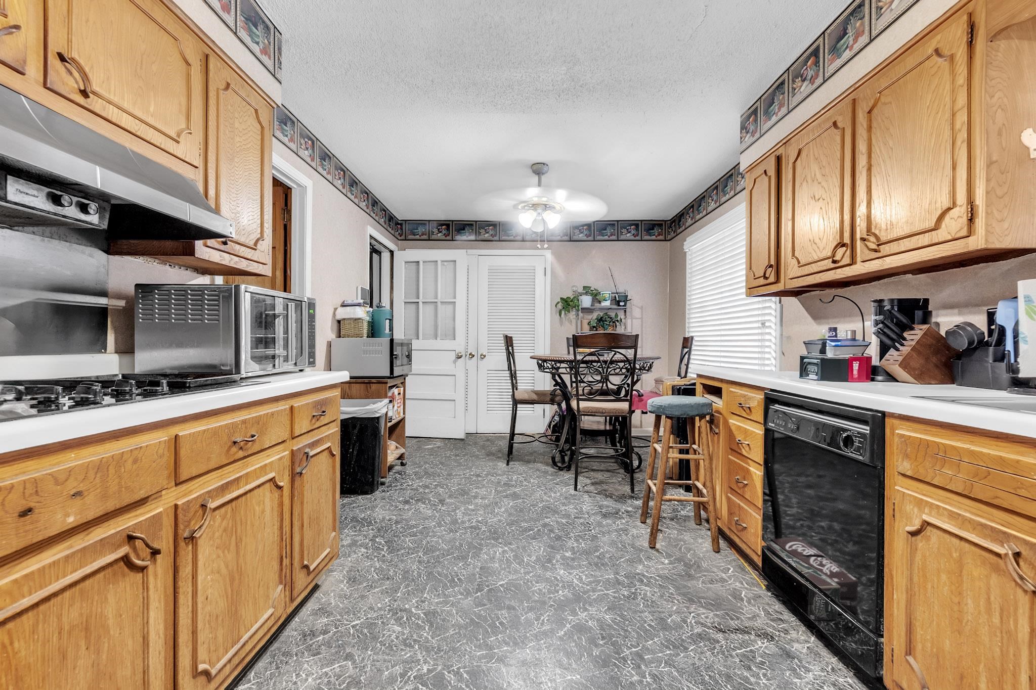 3595 Huckleberry Street Memphis, TN 38116 - Photo 17 of 19 a kitchen with stainless steel appliances granite countertop a sink and cabinets