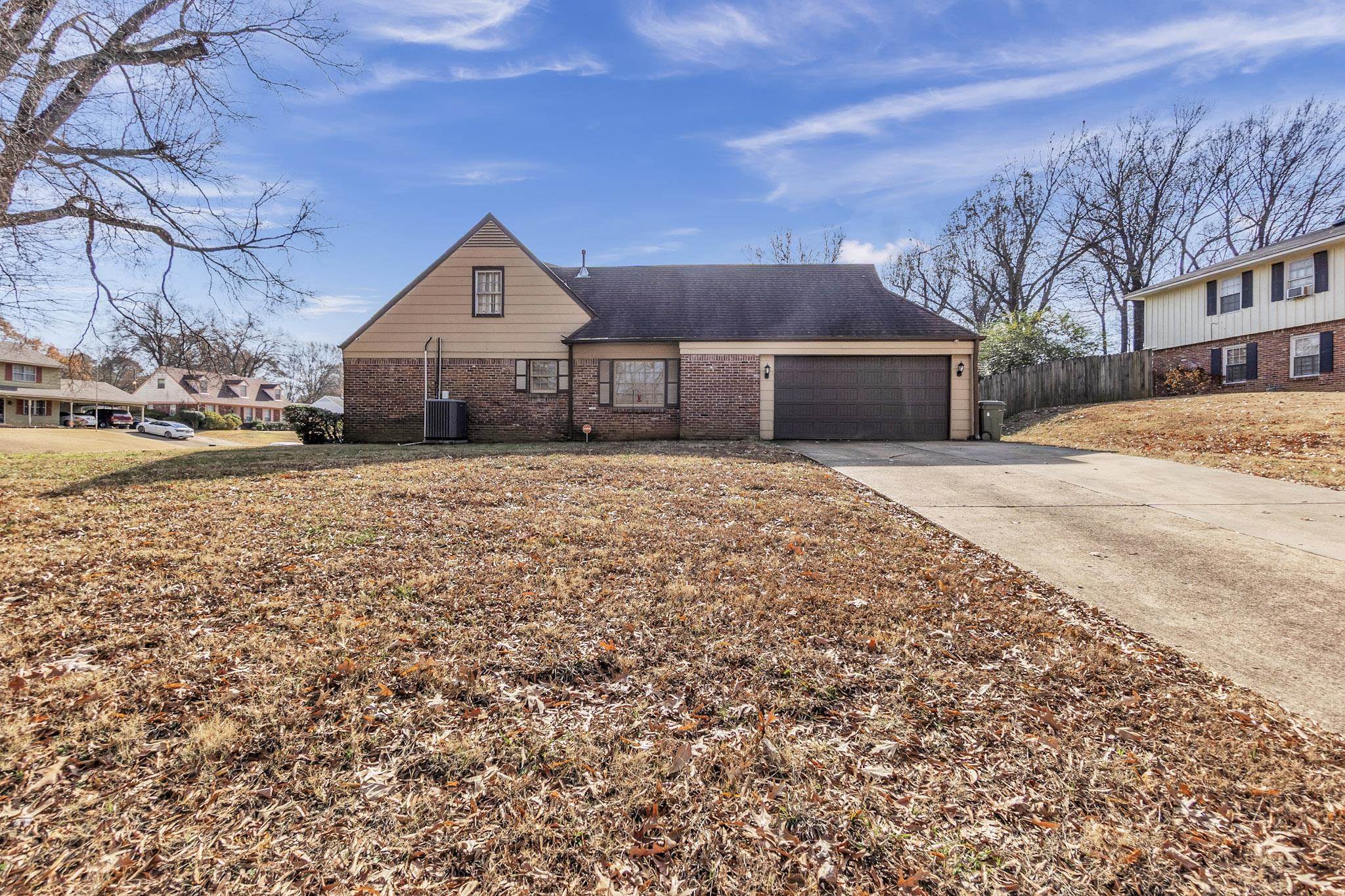 3595 Huckleberry Street Memphis, TN 38116 - Photo 4 of 19 a front view of a house with a yard and garage