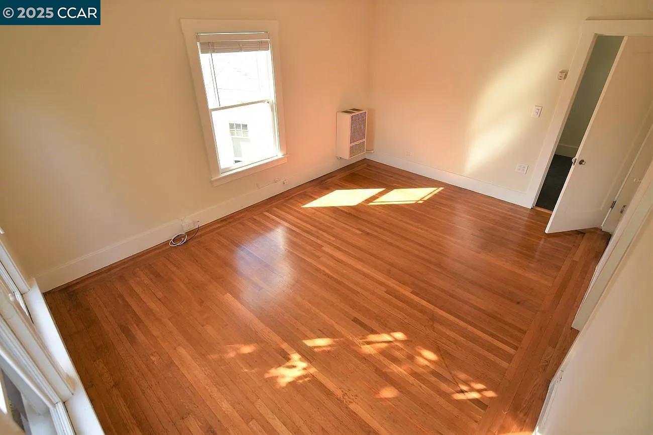 3040 Telegraph Avenue, Unit 4 Berkeley, CA 94705 - Photo 2 of 8 a view of empty room with wooden floor and fan