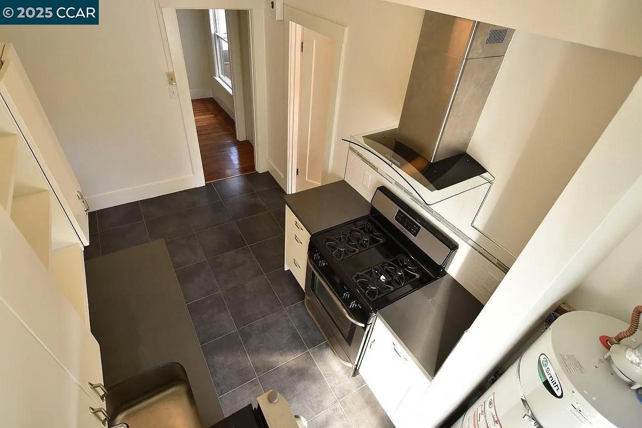 3040 Telegraph Avenue, Unit 4 Berkeley, CA 94705 - Photo 4 of 8 a view of an empty room with wooden floor and stairs