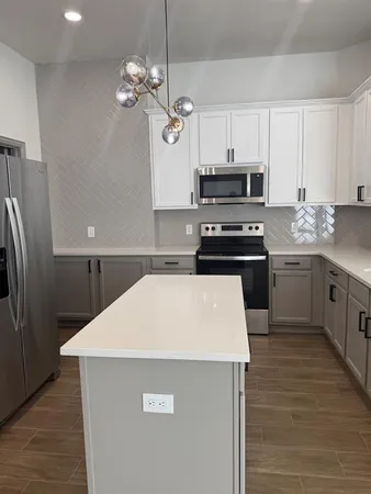 a kitchen with stainless steel appliances a refrigerator sink and cabinets